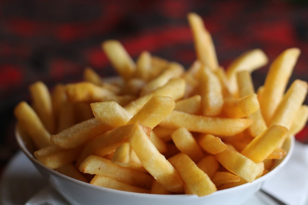 fried-potatoes-1583884 Delicious crispy golden french fries served in a white bowl, perfect for a tasty snack.